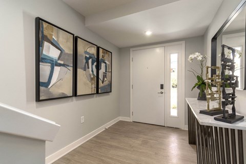 a hallway with paintings on the wall and a door